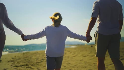Long haired school-age boy holding hands