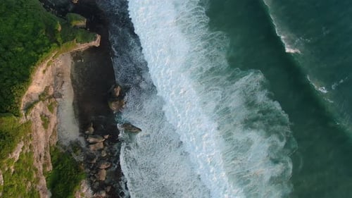 Aerial View of Ocean and Waves Breaking on Rocks on The Beach Near Cliff Bali Indonesia
