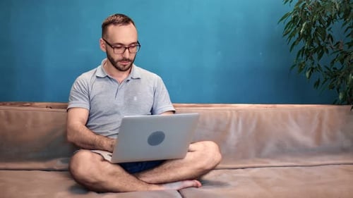 Young Adult Working on Laptop at Home