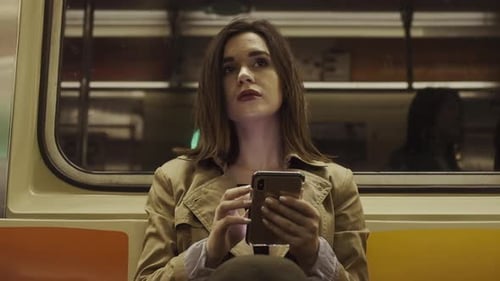 Woman Using Phone on Subway Train Commute