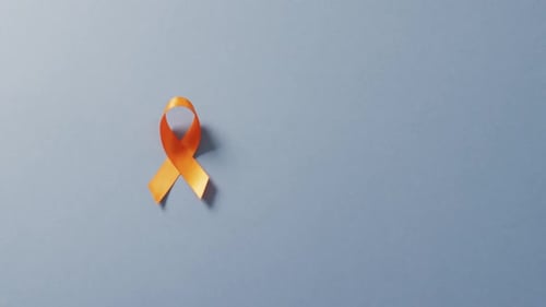 Orange Ribbon Awareness Knot on Gray Background