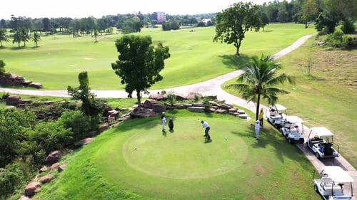 4K Aerial view group of Asian people golfing on at golf course in summer sunny day.