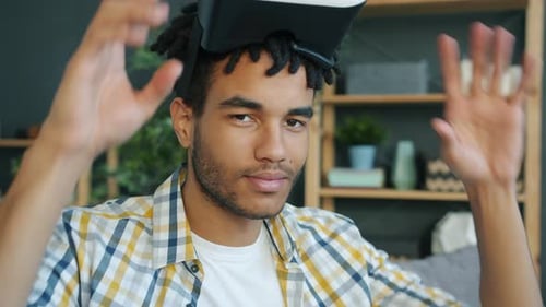 Young Man Wearing VR Headset in Apartment