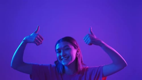 Smiling Young Woman Gives Thumbs Up Approval