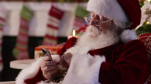 Santa Claus using cell phone, closeup