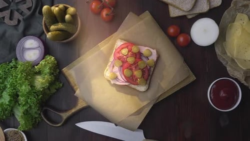 Ingredients Placed Around a Cutting Board With Sandwich