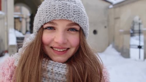 Closeup of Cheerful Positive Young Woman Face Smiling to Camera While Standing Outdoors in Winter