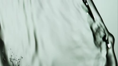 Water pouring and splashing in ultra slow motion 1500fps on a reflective surface - WATER POURS