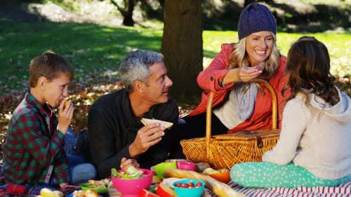 Happy Family Picnic in Autumn Park