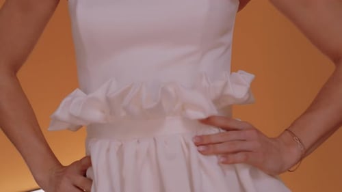 Woman Posing in White Dress with Gold Chain