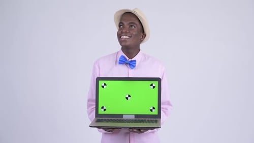 Young Adult Holding Laptop with Green Screen