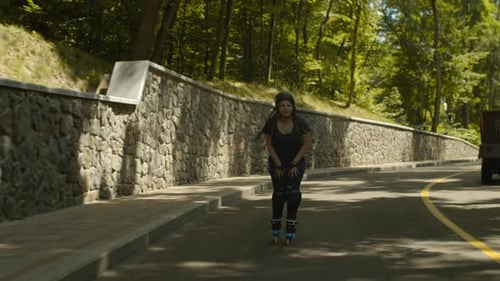Happy Woman Riding Roller Skates at Speed Downhill