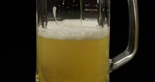 Beer Pouring into a Glass Mug