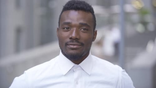 Close-up Portrait of Handsome Smiling African American Man in White Shirt Looking at Camera