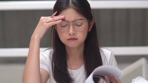 Young undergraduate girl stress tired have problem while study hard for knowledge.
