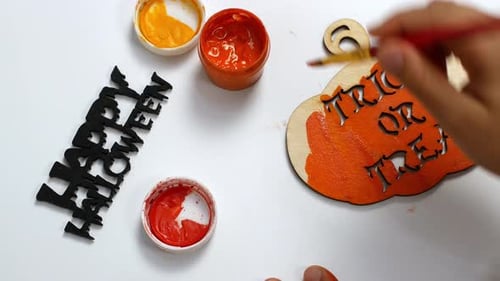 Halloween paints and decor. Children make Halloween decorations with their own hands.