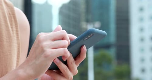 Woman Using Smartphone in Urban Setting Close Up