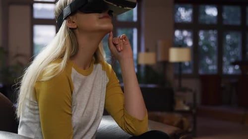Young Woman Enjoying Virtual Reality Experience with Headset