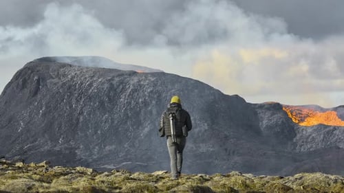 Man Walking Towards Lava Flow From Erupting Fagradalsfjall Volcano