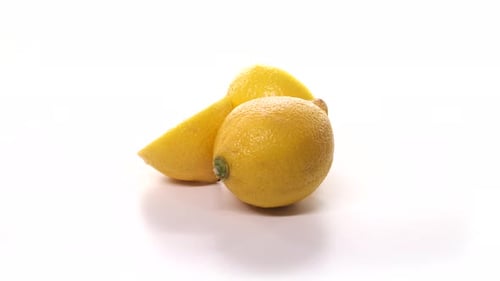 Fresh Lemons Rotating on White Surface