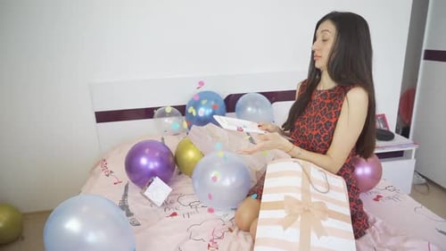 Woman Celebrating Birthday with Gifts and Balloons
