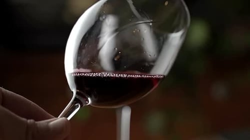 Hand Swirling Red Wine in a Glass