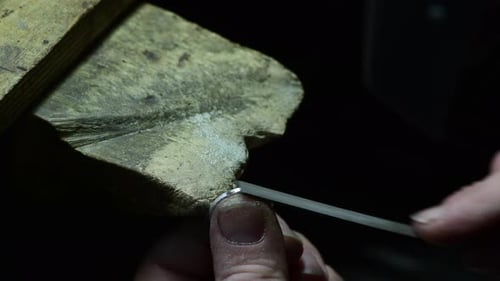 Closeup of Wedding Ring Polishing By Caicasian Jeweler Isolated Footage