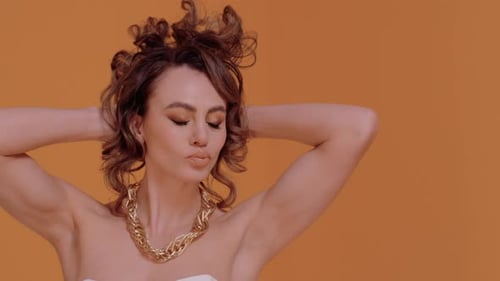 Glamorous Woman Posing with Gold Chain Necklace