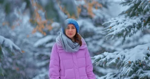 Cute Young Woman Walks Through the Winter Forest Tall Pine Trees Stand in the Snow