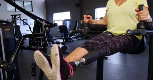 Senior woman doing abs exercise in fitness studio