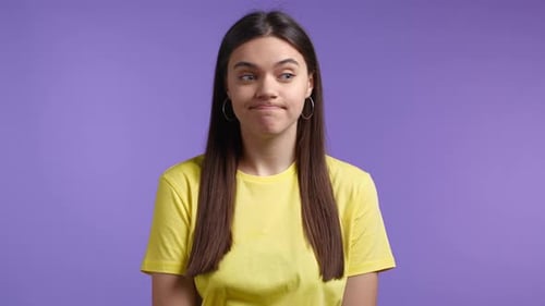 Woman Making Funny Faces Against Purple Background