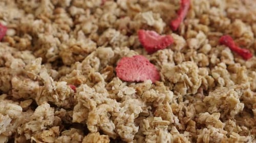 Dehydrated crunchy cereals slow tilt 4K 2160p 30fps UltraHD footage - Tilting over muesli with str