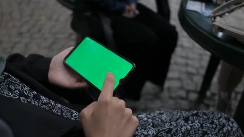 Finger Touching Mobile Phone with Green Screen Display