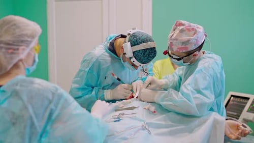 Surgeons Performing Operation in Bright Operating Room