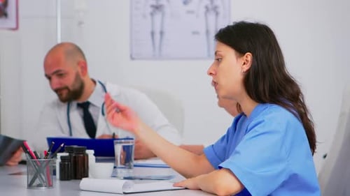 Medical Professionals Collaborate During Hospital Meeting