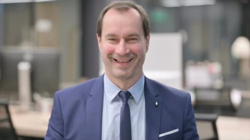 Corporate Man Smiling in Office Setting
