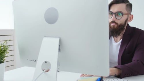 Concept of Office Work or Freelancing, Young Bearded Stylish Man Working at the Computer