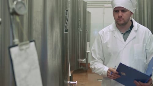Worker Takes Readings at a Brewery