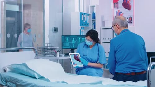 Doctor Explains Heart to Senior Patient in Hospital
