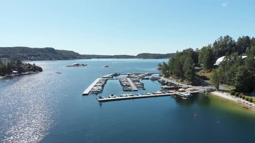 Boats in harbour in blue coastal water, aerial summer view