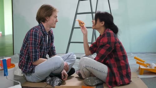 Couple Eating Pizza During Home Improvement Project