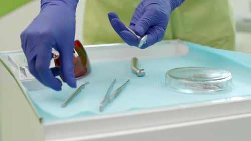 Dental Worker Arranging Tools in a Medical Setting