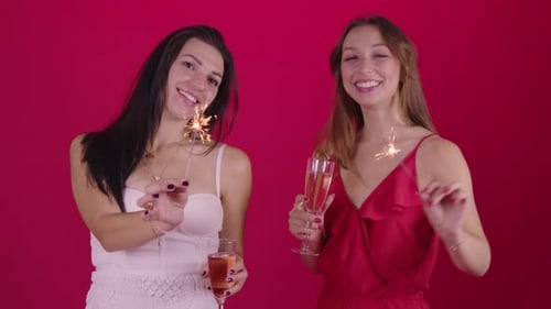 Women Celebrating with Champagne and Sparklers