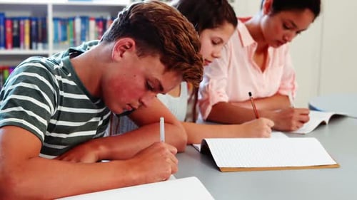 School kids doing homework in library