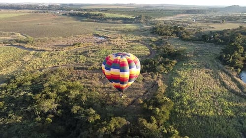 Colorful Hot Air Balloon over Lush Green Landscape