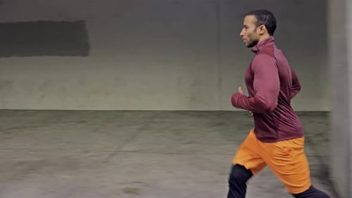 Athletic Male Running Through A Tunnel