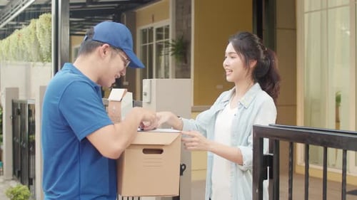 Young postal delivery courier man holding parcel boxes for sending to customer