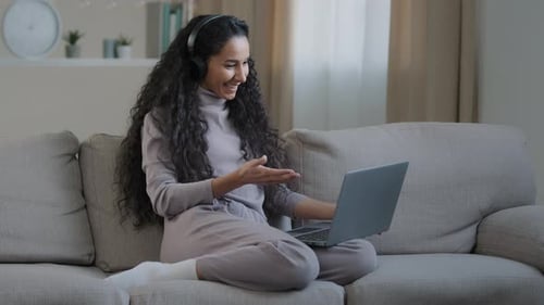 Woman with Laptop Having a Video Call at Home
