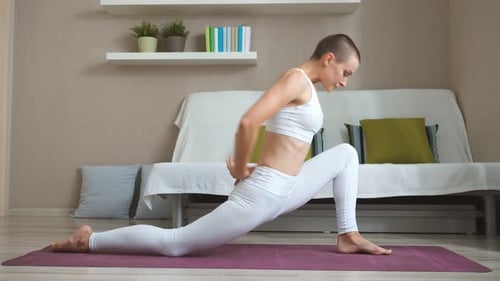 Woman Performing Yoga Stretching Exercises Indoors