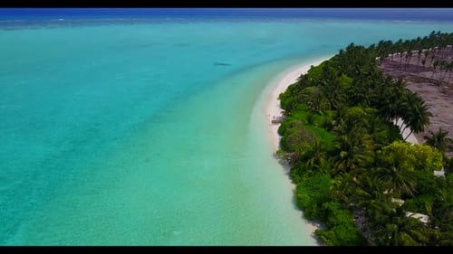 Aerial drone view panorama of tranquil tourist beach vacation by blue water with white sand backgrou